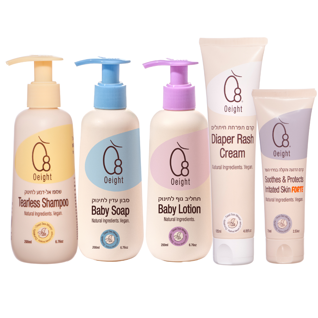A set of five baby care products with pump bottles, including products labeled as baby soap, baby lotion, diaper rash cream, and a teardrop-shaped bottle possibly for shampoo.